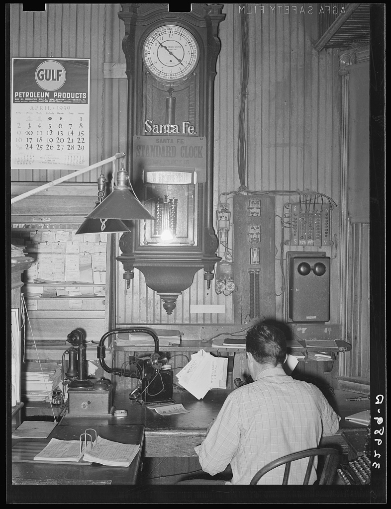 Public domain photograph of a train dispatch office with telegraph and communication equipment.