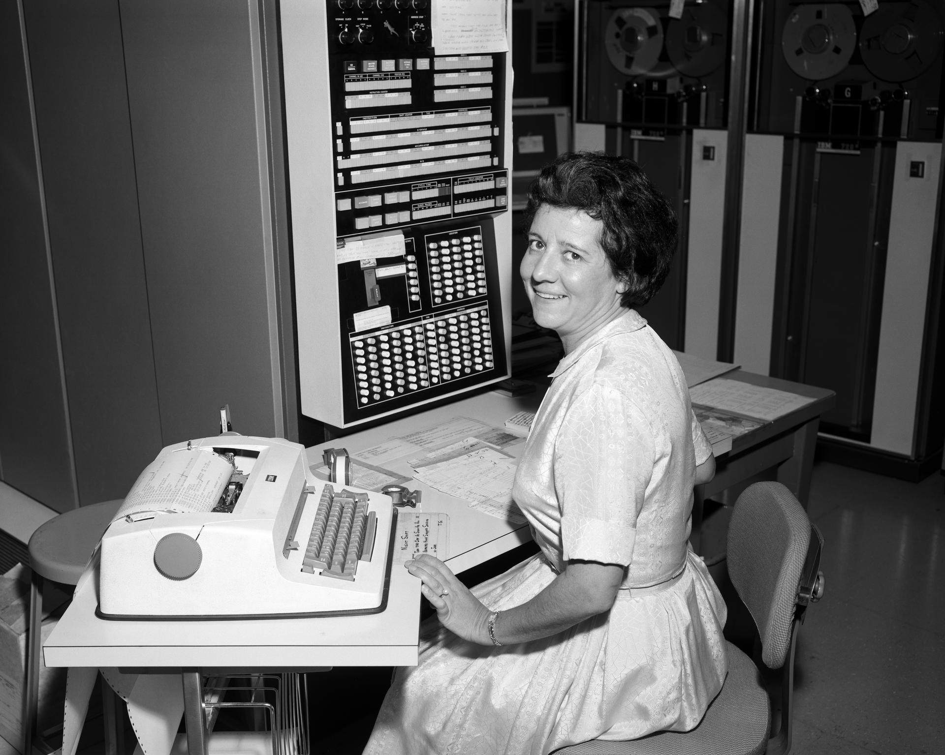 Public domain NASA photograph of a computer operator working at an early IBM machine.