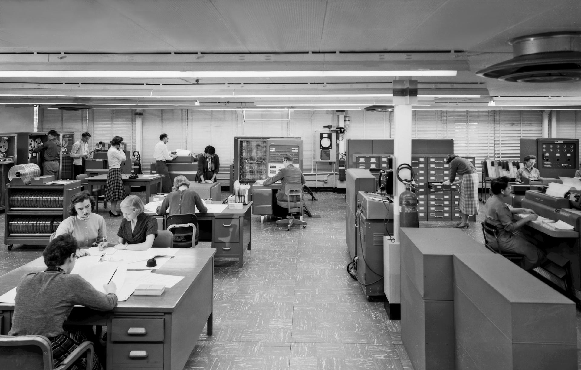 Public domain NASA photograph of operators working around an IBM 704 computer system.